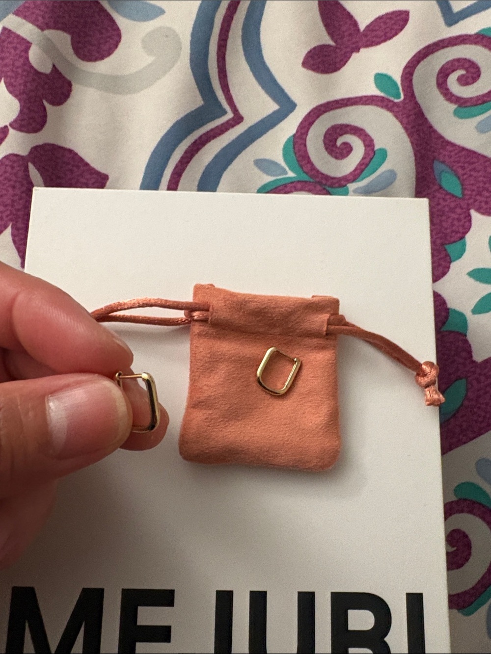 10k gold Huggie U Hoops with original packaging